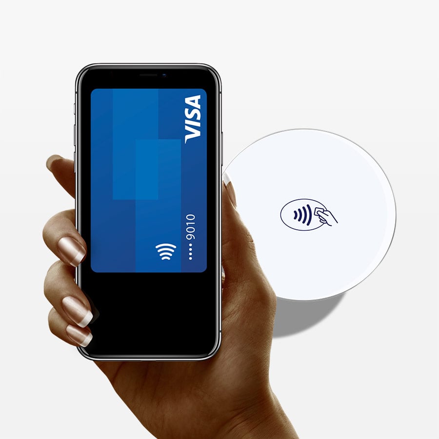 A hand holding a smartphone on which there is a Visa payment card representing Visa's digital payment options