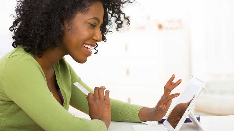 Smiling woman using a tablet.